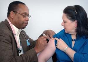 Flu season decorative photo: physician administering a vaccine to a patient