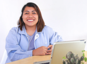 Woman smiling at computer telehealth health equity